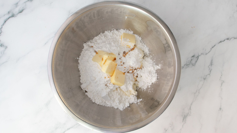 Butter and powdered sugar in mixing bowl