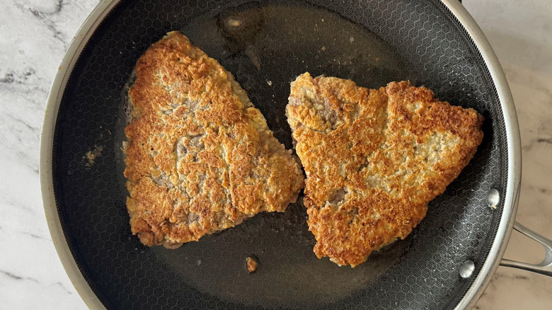 Browned steaks in pan