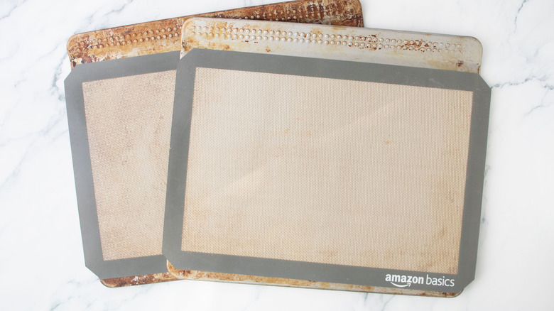 Two baking sheets lined with silicon mats