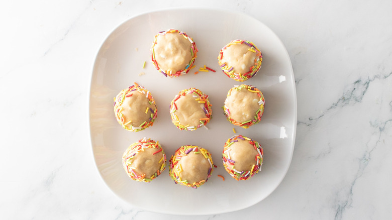 Cookie dough balls with sprinkle rims on plate