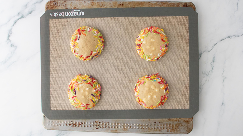 Sprinkle rimmed baked cookies on cookie sheet