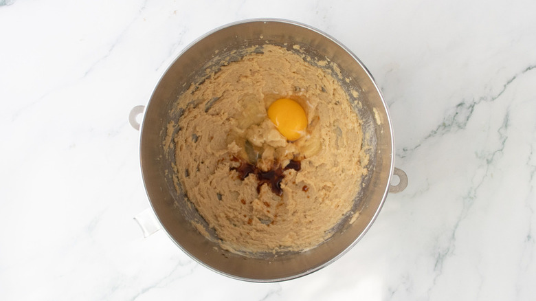 Brown sugar and butter mixture in bowl with egg and vanilla