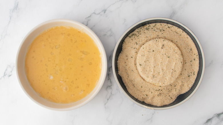 coating cheese patty in breadcrumbs