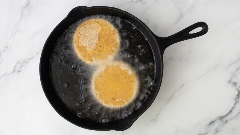 frying cheese patties in skillet