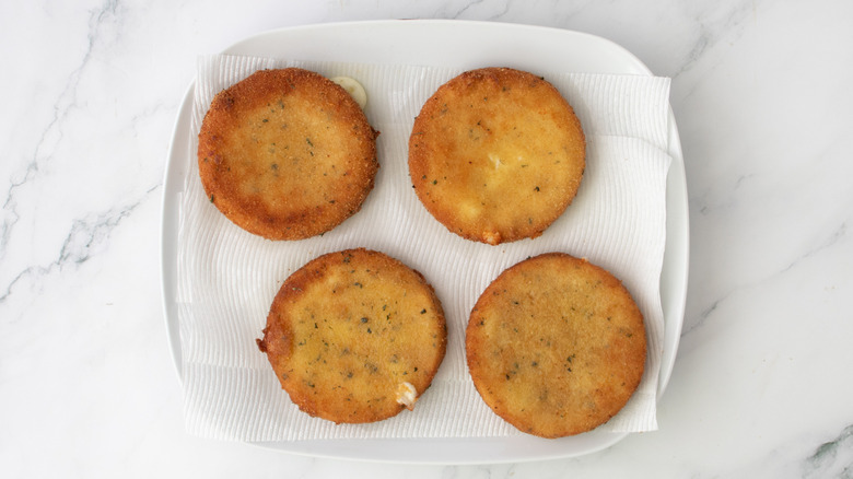 fried cheese patties on paper towel lined plate