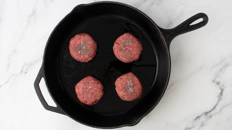 burger balls searing in skillet