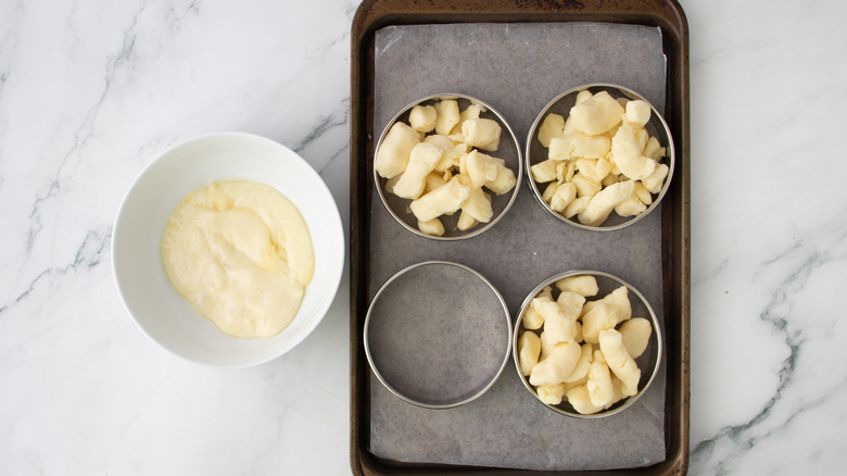 whole and melted cheese curds in ring molds and bowl