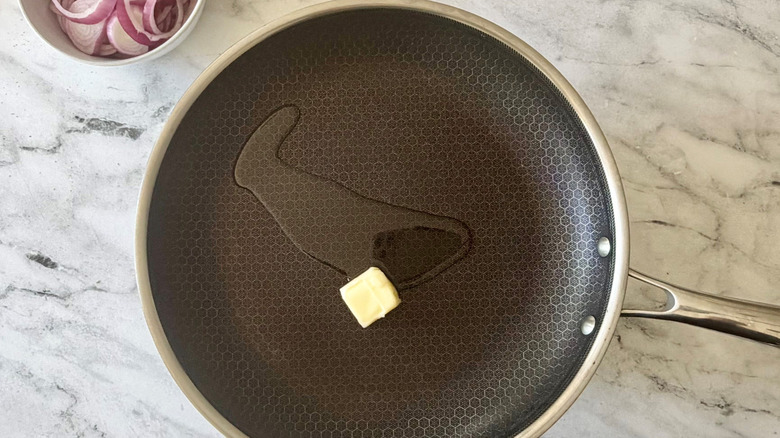 Drizzle of oil and pat of butter in pan