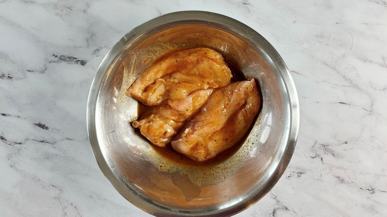 Marinated chicken breasts in bowl