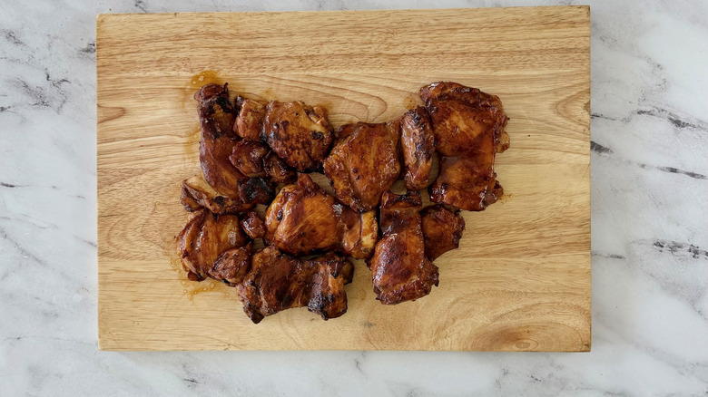 Cooked chicken on wooden board