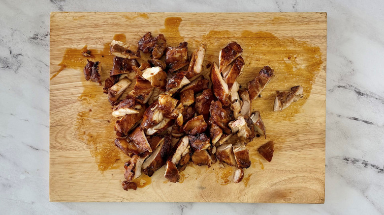 Sliced chicken on wooden board
