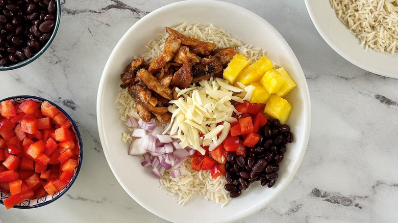 Hawaiian chicken burrito bowl with various toppings