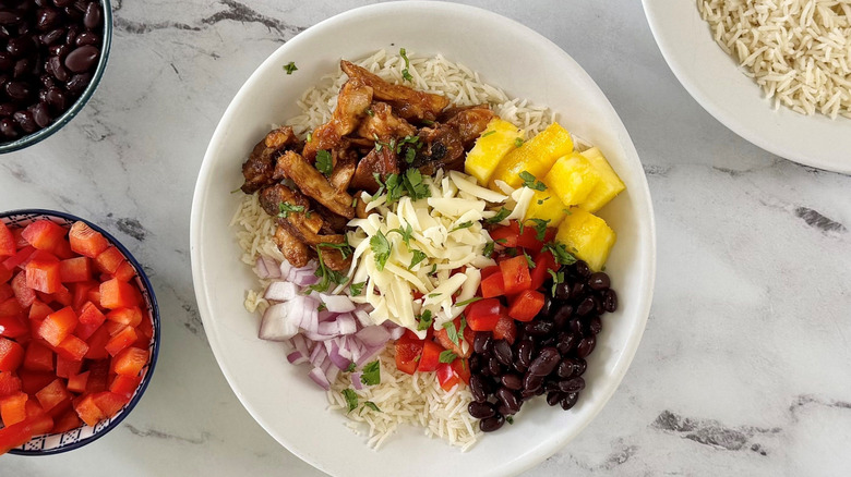 Hawaiian chicken burrito bowl with various toppings