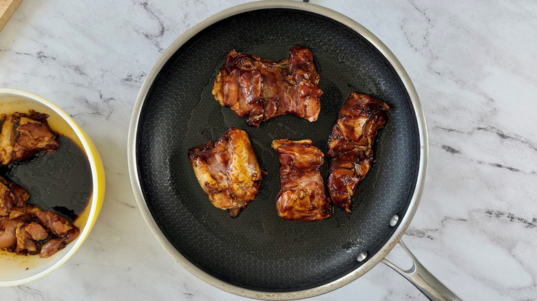 Marinated chicken thighs in pan