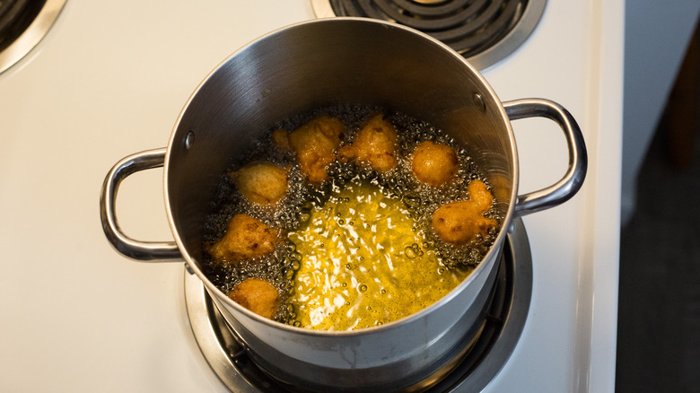 dough frying in medium pot