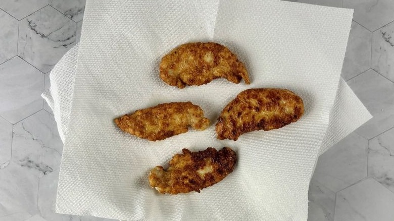 Chicken tenders sitting on paper towels