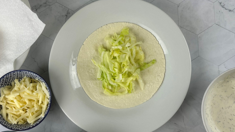 Lettuce on tortilla on plate