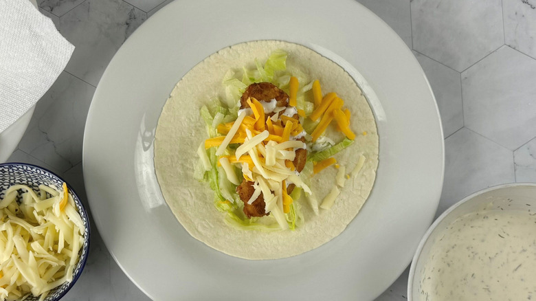 Unwrapped chicken snack wrap on plate