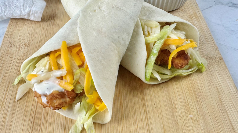 Chicken snack wraps on wooden board