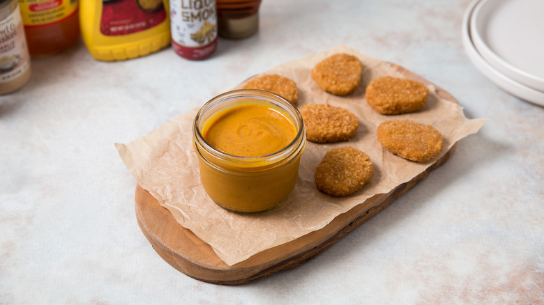 sauce and nuggets on table