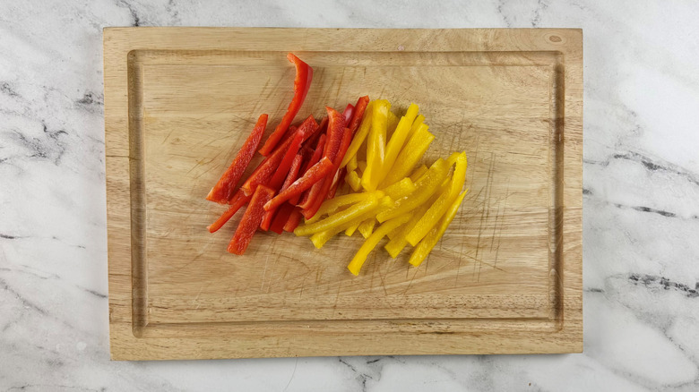 chopped bell peppers on a wooden board