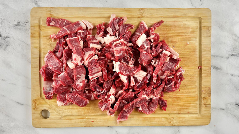 chopped raw steak on a wooden board