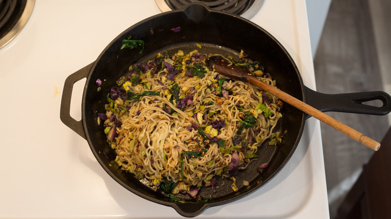 ramen sauteing in iron pan