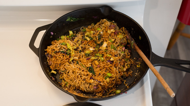 ramen cooking in iron skillet