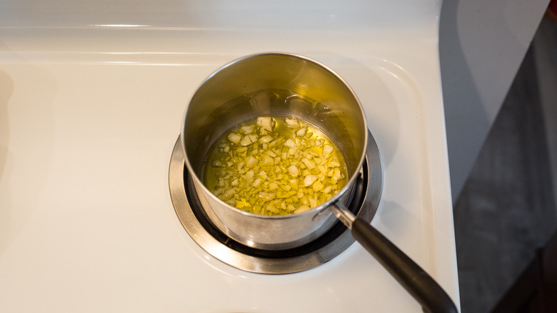 garlic cooking in small saucepan