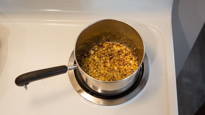 chili oil cooking in saucepan