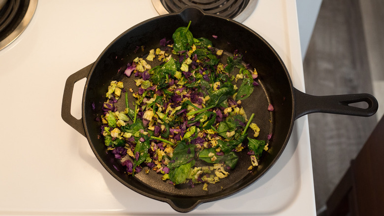 vegetables cooking in iron pan