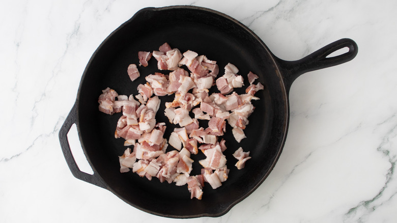 chopped raw bacon in a pan