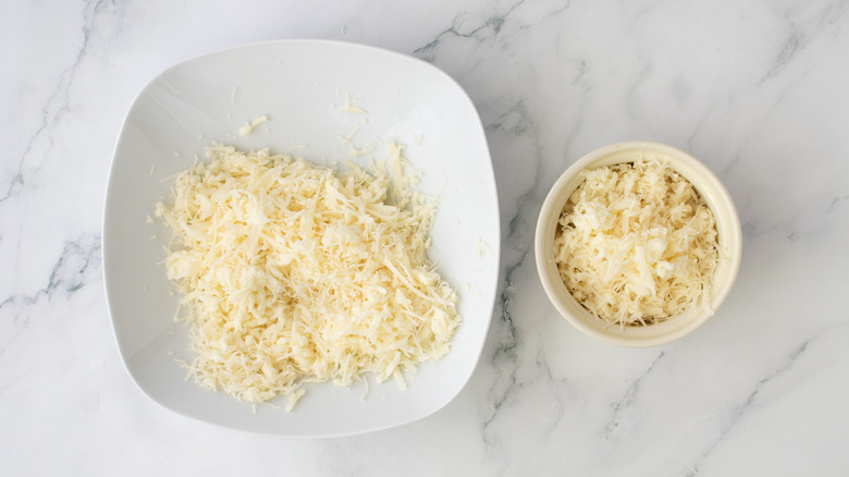 shredded cheese in two white bowls