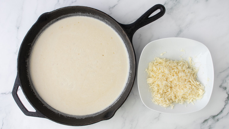 creamy sauce in a black frying pan