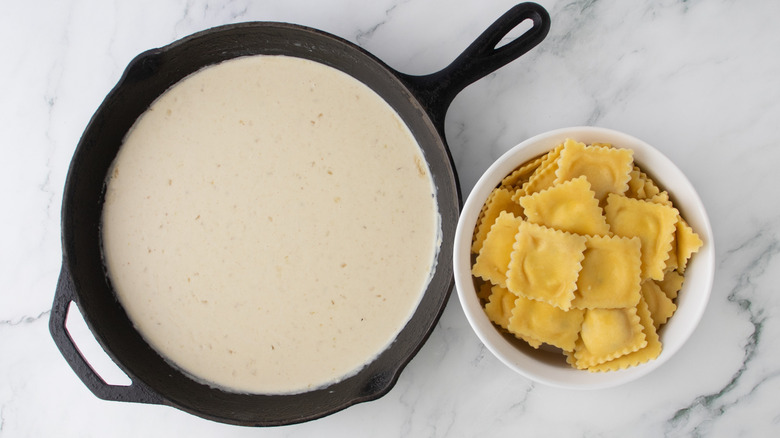 creamy sauce in a black frying pan