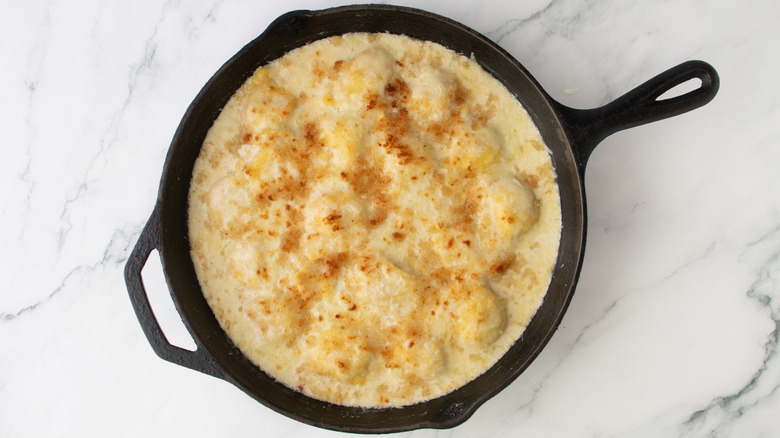 cheesy pasta in a black frying pan