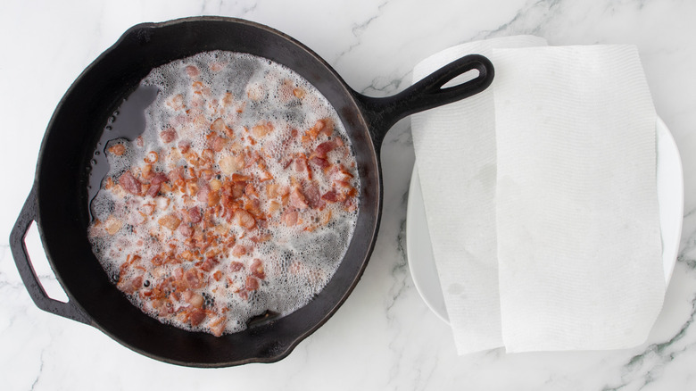 chopped cooked bacon in a pan with bacon grease
