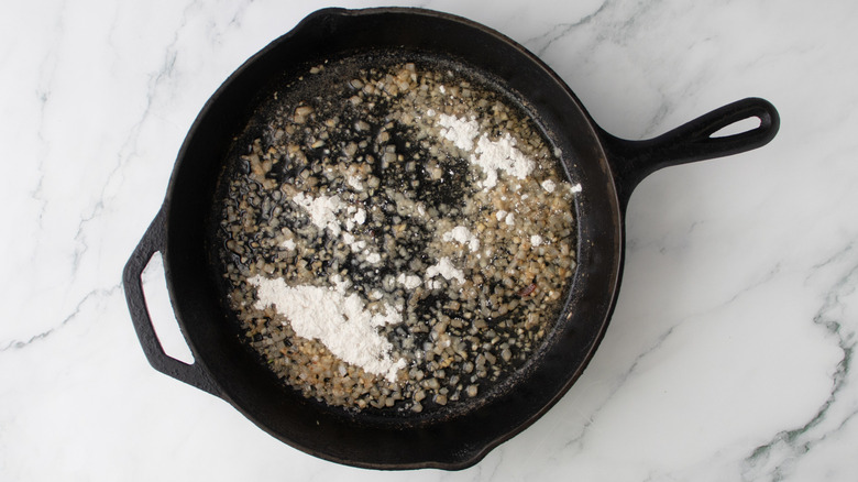 flour in a black frying pan