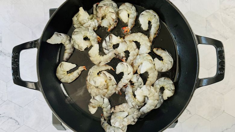Aerial view of uncooked shrimp in large pan