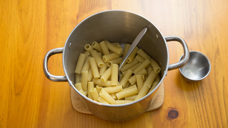 drained pasta in pot with spoon