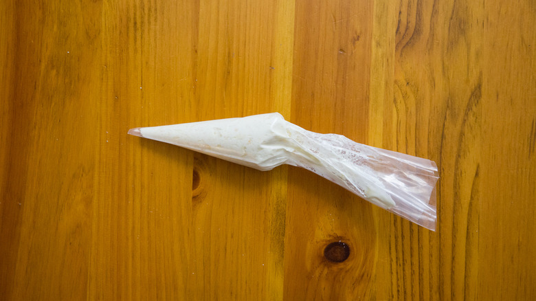 cheese-filled piping bag on table