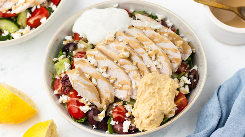 Chicken salad in a bowl with toppings
