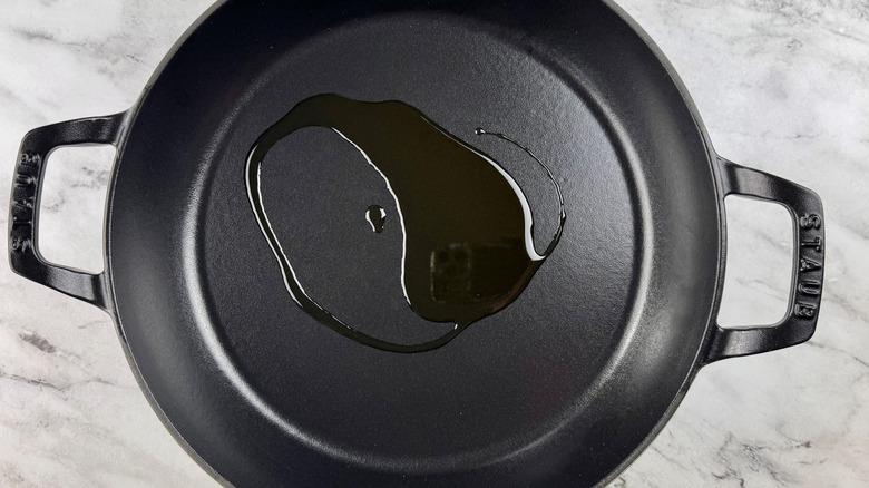 black pot containing a small puddle of oil