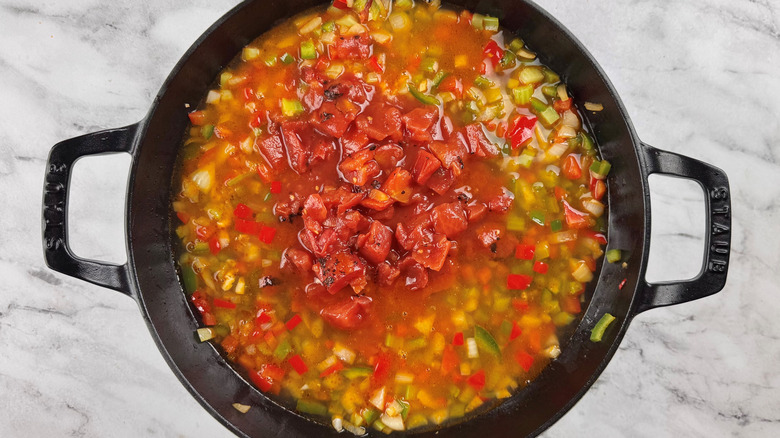 chopped vegetables and liquid in a black pot