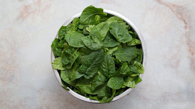 fresh spinach in large bowl
