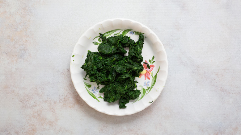 cooked spinach on floral plate