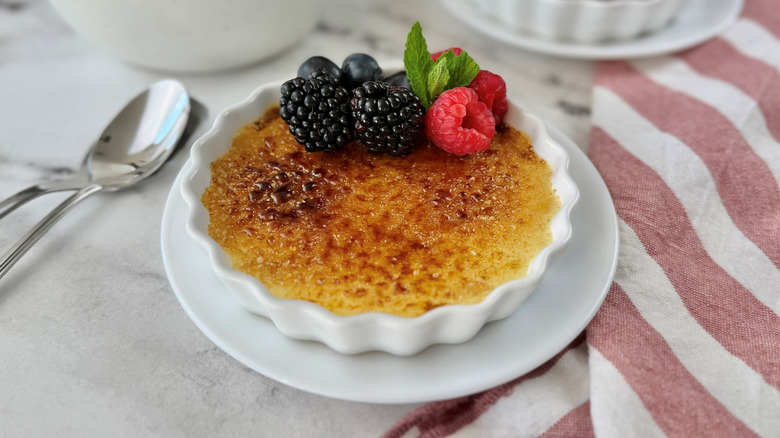 Creme brulee serving in ramekin with berries