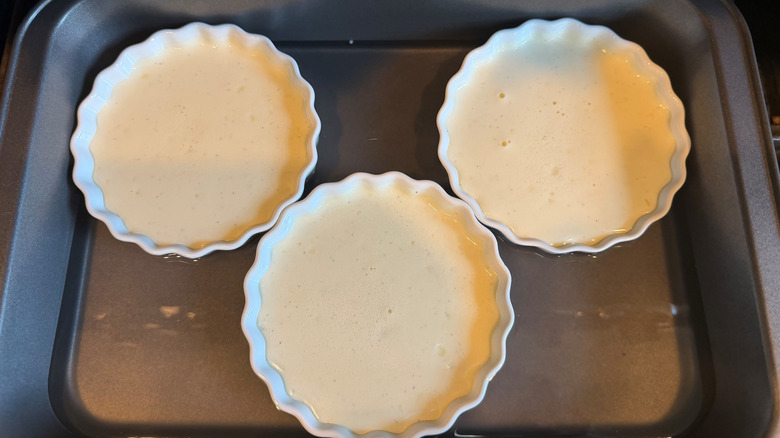 Unbaked creme brulees in baking dish