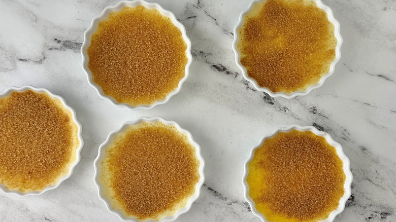 crème brûlée in ramekins with sugar on top