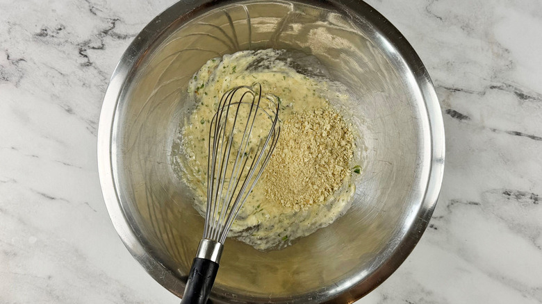 Sauce with crushed crackers and whisk in bowl